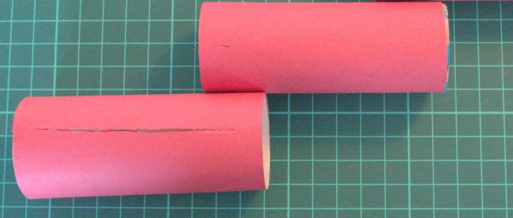 You need to make two slits: one long one, almost the whole length of the larger tube, and one small on 1cm from the end of the smaller tube.