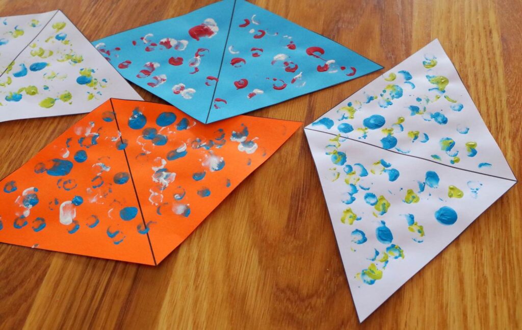 Finger paint bunting, decorated and dried. 