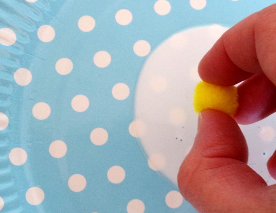 Toddlers can use a pincer grip to dip each pom-pom in glue then stick it onto the paper.