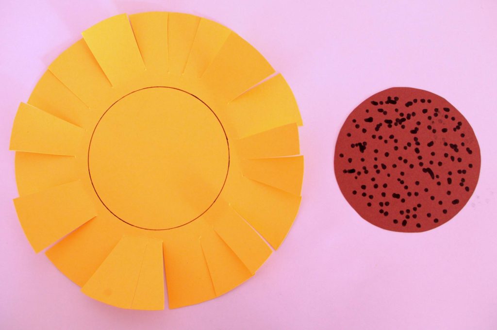 A yellow circle with cuts and a brown circle covered in dots make up the Sunflower Cutting Craft.