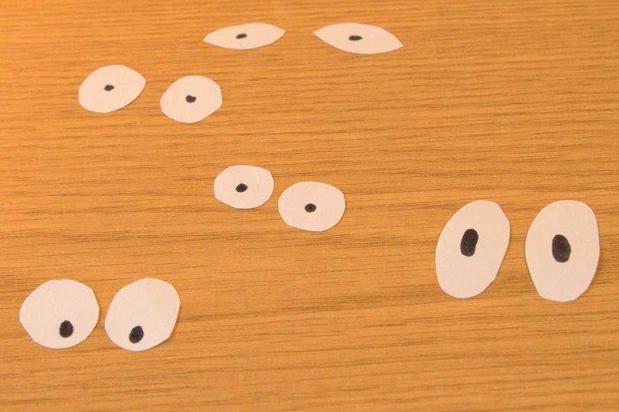Cut out pairs of paper eyes for tube people. 